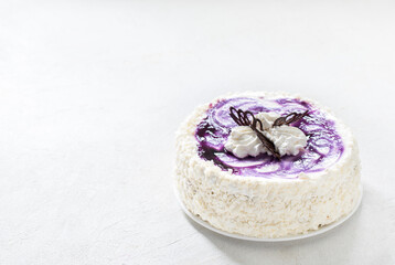 Creamy biscuit blueberry cake with white chocolate on a light background copy space