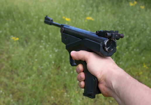 old sports air pistol in a man's hand