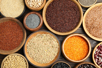 Different grains and seeds on wooden table, flat lay. Veggie diet