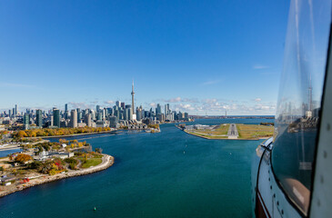 Naklejka premium Aerial image from the approach to Billy Bishop Airport from the west. Toronto harbour and city skyline 