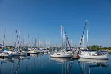 Fototapeta na wymiar Boat and sailboats mored at waterfront park, Toronto, Ontario