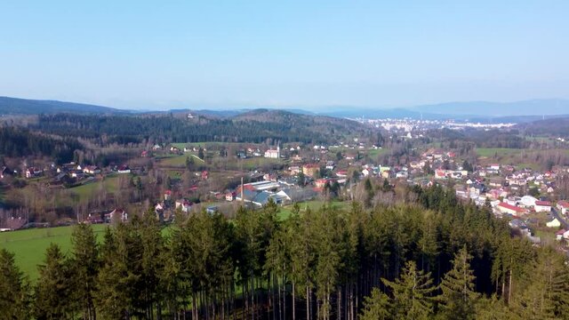 Rural mountain landscape on springtime sunny day. Lucany nad Nisou and Jablonec nad Nisou in Jizera Mountains. Czech Republic. Pedestal up aerial 4K footage from drone