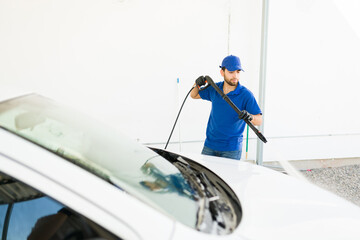 Hispanic worker doing his job at the car wash