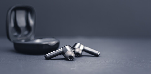 Blank wireless bluetooth earphones on black background