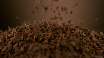 Pouring pieces of instant coffee dry granules