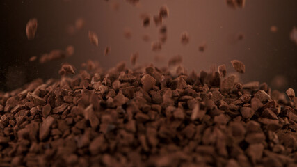 Pouring pieces of instant coffee dry granules