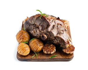 Roast lamb leg with potatoes and rosemary on cutting board isolated on white