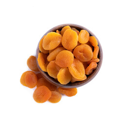 Dried apricots in wooden bowl isolated on white