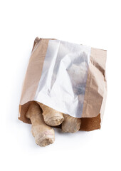 Fresh ginger roots in burlap bag isolated on white