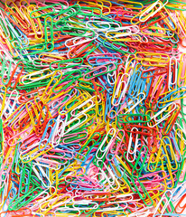 Paperclips colourful rainbow wallpaper. Festive party background made of paper clips for office supplies store