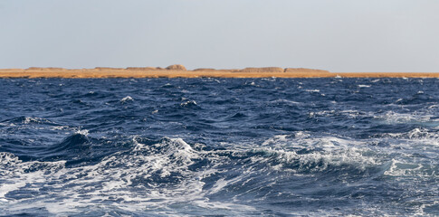 Turbulent flow of a boat wake. Sea wave. The yacht sails, leaving behind a trail and waves.