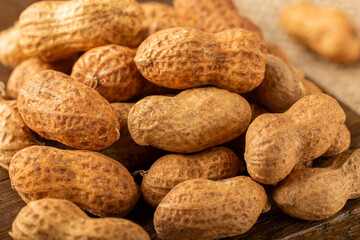 Dry peanut on the wooden background.