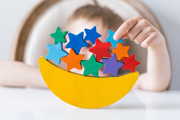 Children's wooden educational toy, a balance beam in the form of a month and stars. Montessori toys.