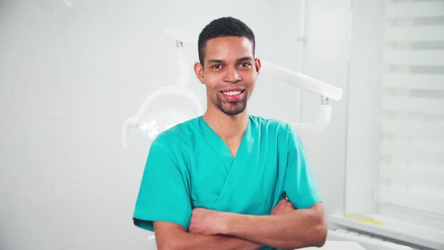 Doctor in the dental office watchng into the camera