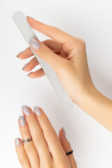 Womans hand with grown manicure on white background with copy space