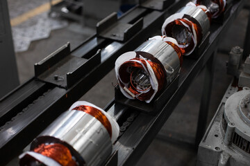 electric motors manufacture in industrial company - stators on assembly line of Semi-automated...