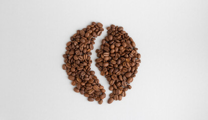 Coffee beans. Isolated on a gray background in the shape of a coffee bean