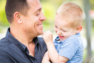 Young Caucasian Father and Son Having Fun At The Park