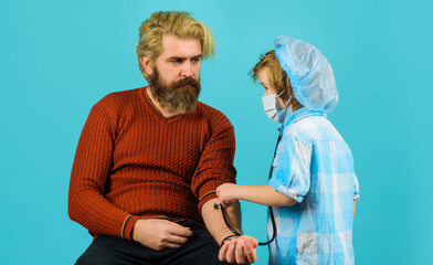 Fathers day. Son play doctor with dad. Child doctor playing with father. Kid Game.