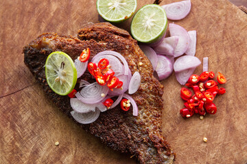 Fried Fermented Fish, Pickled Fish on a Wooden Table in the Kitchen for Lunch.