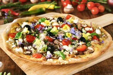Fresh homemade pizza: Colorful Garden with vegetables and feta cheese, garnished with flowers - 434444725