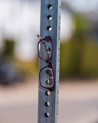 Lost and broken prescription eye glasses hung on a street sign pole in Toronto’s Beaches neighbourhood.
