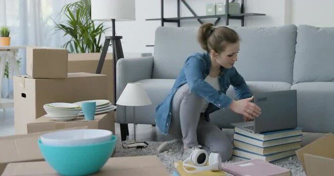Happy woman doing a home relocation and connecting online
