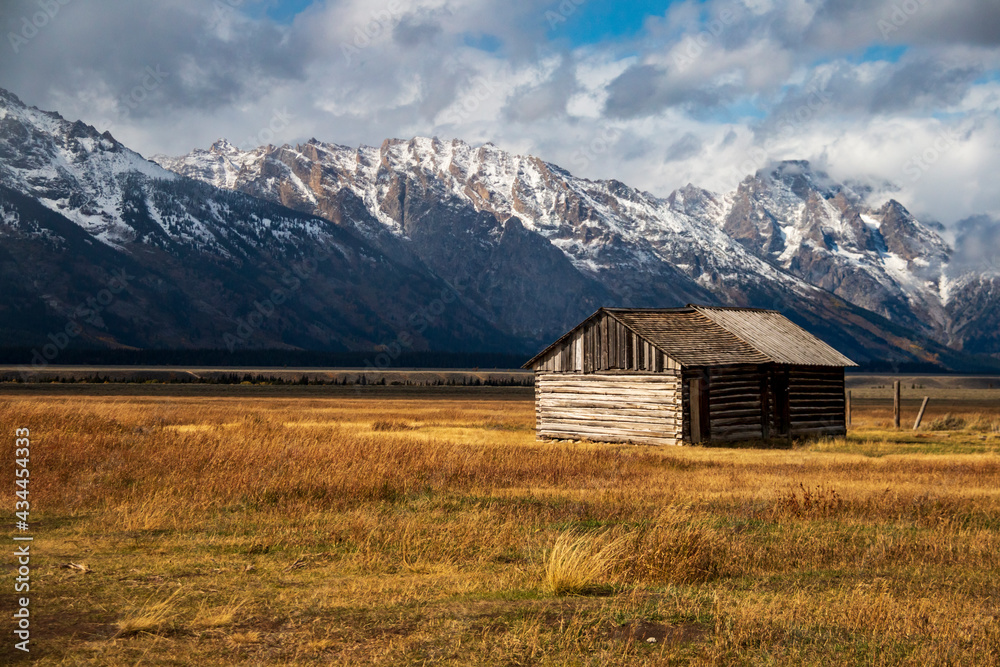 Wall mural historic moulton barns n mormons' row against the dramatic teton mountain range in wyoming.