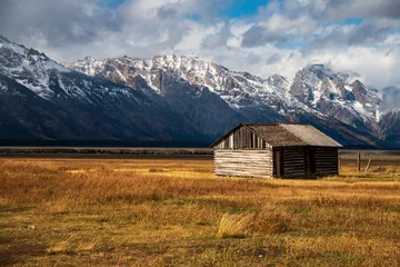 Foto op Canvas historic Moulton barns n Mormons' Row against the dramatic Teton mountain range  in Wyoming. © Nathaniel Gonzales