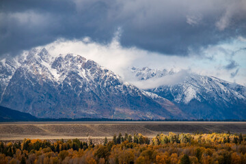 snow capped jagged peaks of the Grand teton mountain range in wyoming during autumn.