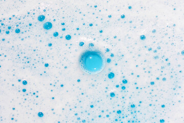 Soap foam on blue background.