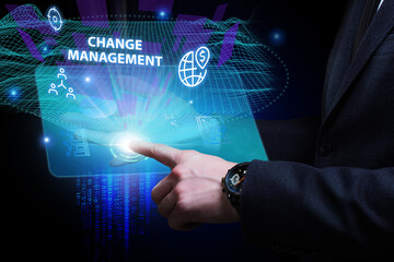 Business, Technology, Internet and network concept. Young businessman working on a virtual screen of the future and sees the inscription: Change management