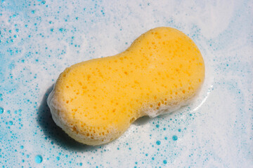 Yellow sponge in soap foam