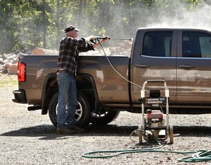 Man power washing pickup truck © Joylyn McChesnie