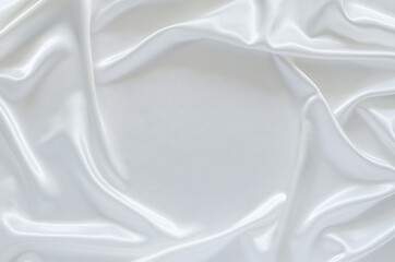 Smooth elegant wavy white satin cloth texture background with space for text. Abstract, texture and wedding concept.