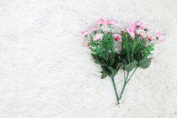 bouquet of flower on white artificial wool background