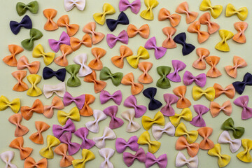 Colorful Italian pasta background. Various colors of bow tie farfalle pasta. Top view. Selective focus.