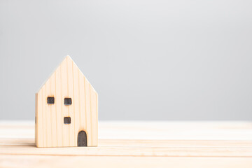 wooden house model on table background. Home, Crisis, Economic recession, Homeless, Real Estate, Buy or Rent and Property concept