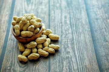 Peanuts on wooden bowl.