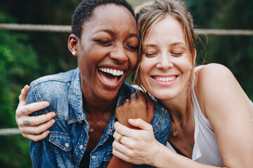 Happy black woman laughing with her friend