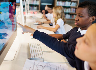 Young students using computers in class