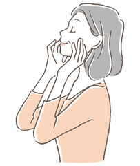 頬に手を当て気持ちよく目を閉じるシニア女性
