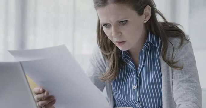 Disappointed woman reading a rejection letter