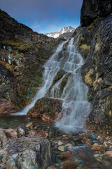 Obraz premium waterfall in Glencoe, highlands, Scotland with mountain scenery in the background.