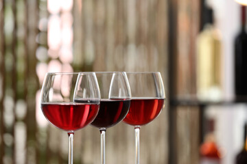 Different sorts of wine in glasses indoors, closeup