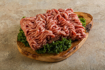 Raw pork minced meat over board