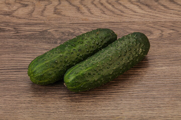Green fresh cucumbers over background