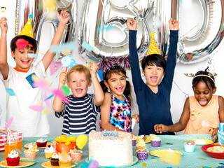 Diverse kids enjoying a birthday party - Powered by Adobe
