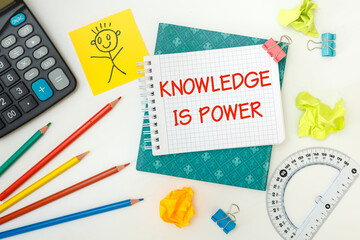 Notebook with school supplies and the inscription KNOWLEDGE IS POWER