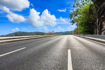 Mountain road landscape under blue sky.